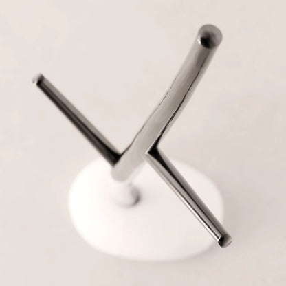 High-angle view of the branching dark wood structure and white base of the Winter Tree coat stand by Antony Gasnier