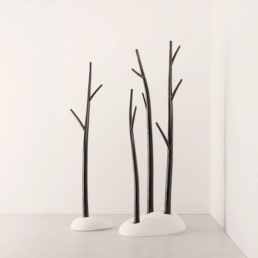 Three Winter Tree coat stands by Antony Gasnier in different heights with dark wood branches and white upholstered bases