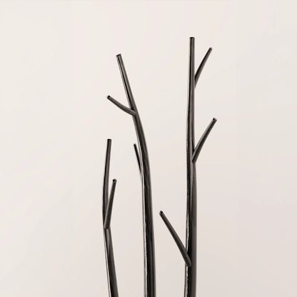 Upper detail of the Winter Tree Coats Triple by Antony Gasnier, featuring three dark wood trunks with sculptural branch hooks.