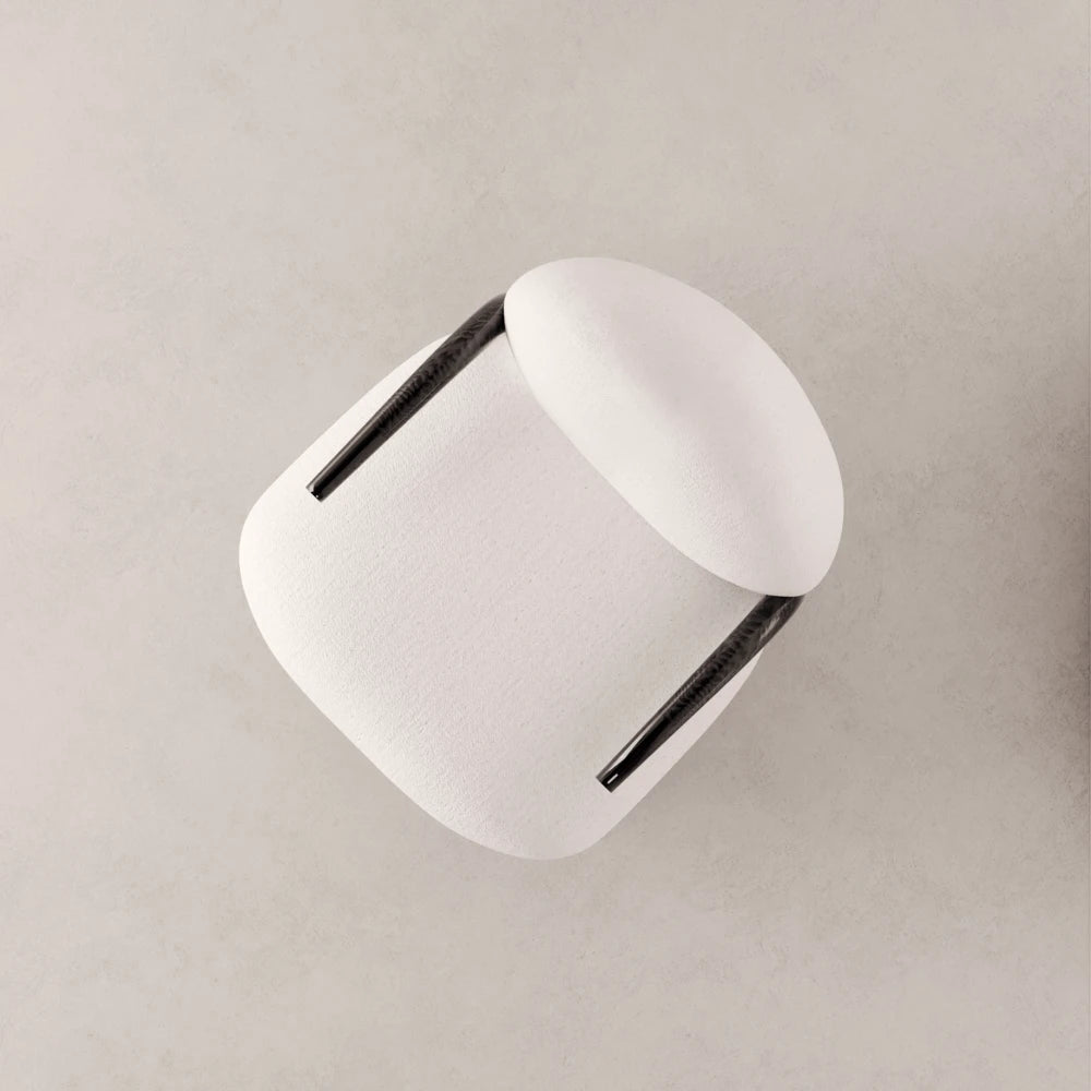 High-angle view of the Winter Armchair by Antony Gasnier, showing its upholstered white volumes and curved solid oak armrests
