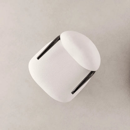 High-angle view of the Winter Armchair by Antony Gasnier, showing its upholstered white volumes and curved solid oak armrests