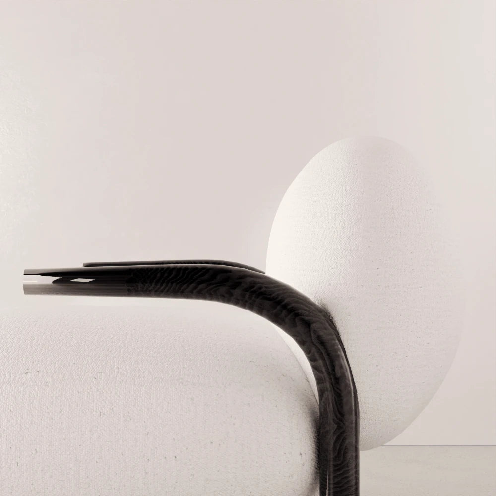 Close-up of the dark solid oak armrest and textured white upholstery of the Winter Armchair by Antony Gasnier