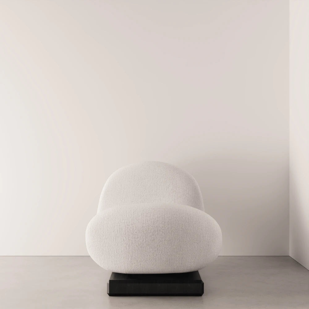 Front view of the Winter Daybed by Antony Gasnier with a rounded white fabric seat and raised curved backrest