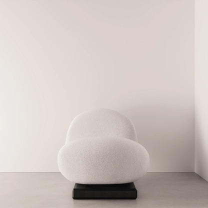 Front view of the Winter Daybed by Antony Gasnier with a rounded white fabric seat and raised curved backrest