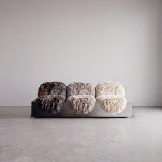Isolated front view of the Sans Poids Gradient sofa by Diamant Versatile, featuring three long-haired fur seats on a brushed metal base.
