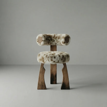 Front view of the Solum dining chair by Diamant Versatile, with cylindrical shearling cushions and angular walnut legs.