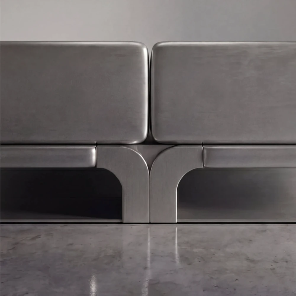 Close-up of the Confluence bed’s brushed metal panels and symmetrical curved central junction by Diamant Versatile.