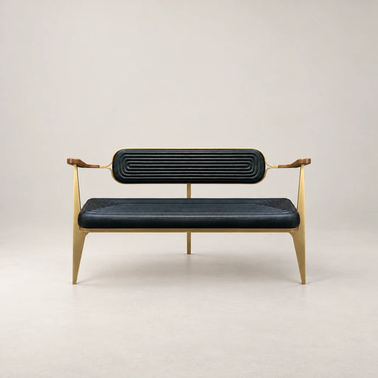 Front view of the BH01 Bench by Eva Szumilas, featuring ribbed black leather seat and back cushions, wooden armrests and slender gold-toned legs.