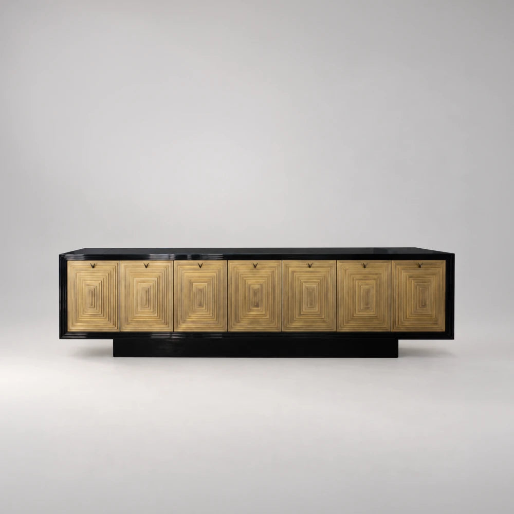 Front view of the C22 Sideboard by Eva Szumilas, featuring seven gold-toned doors with concentric rectangular reliefs, a glossy black frame and plinth.