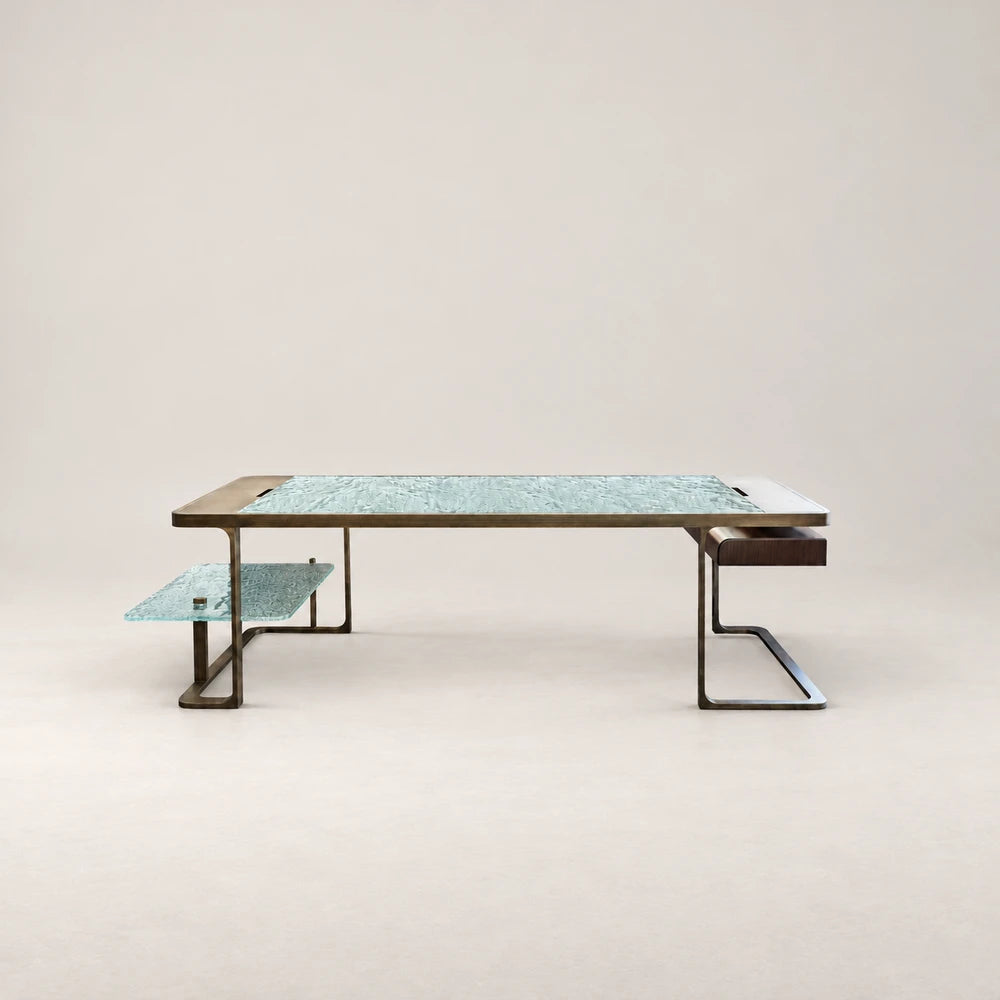 DK01 Desk by Eva Szumilas, with a textured pale turquoise glass top, bronze-toned metal frame, matching lower glass shelf and dark wooden drawer.