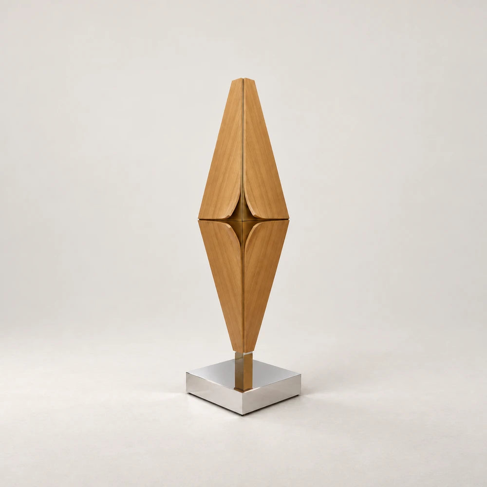 Diamond Bar Cabinet by Eva Szumilas, with a tall diamond-shaped wooden body, curved door edges, gold-toned central detailing and a polished square metal base.