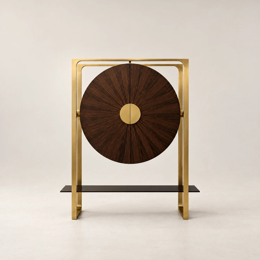 Front view of the Gong Bar Cabinet by Eva Szumilas, with circular wooden doors, radiating grain, central gold-toned handles and a rectangular metal frame.
