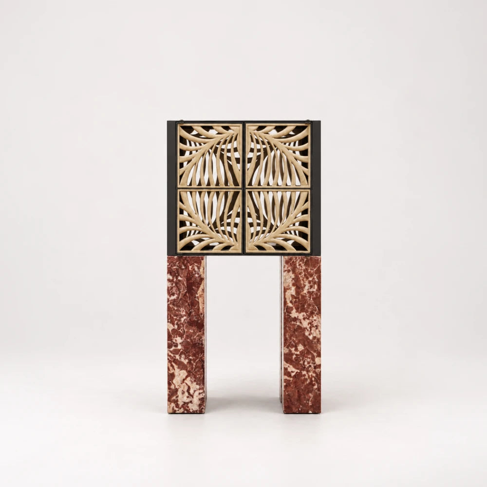 Front view of the Hikari Bar Cabinet by Eva Szumilas, with curved beige stone lattice doors, a dark frame and tall red marble legs.