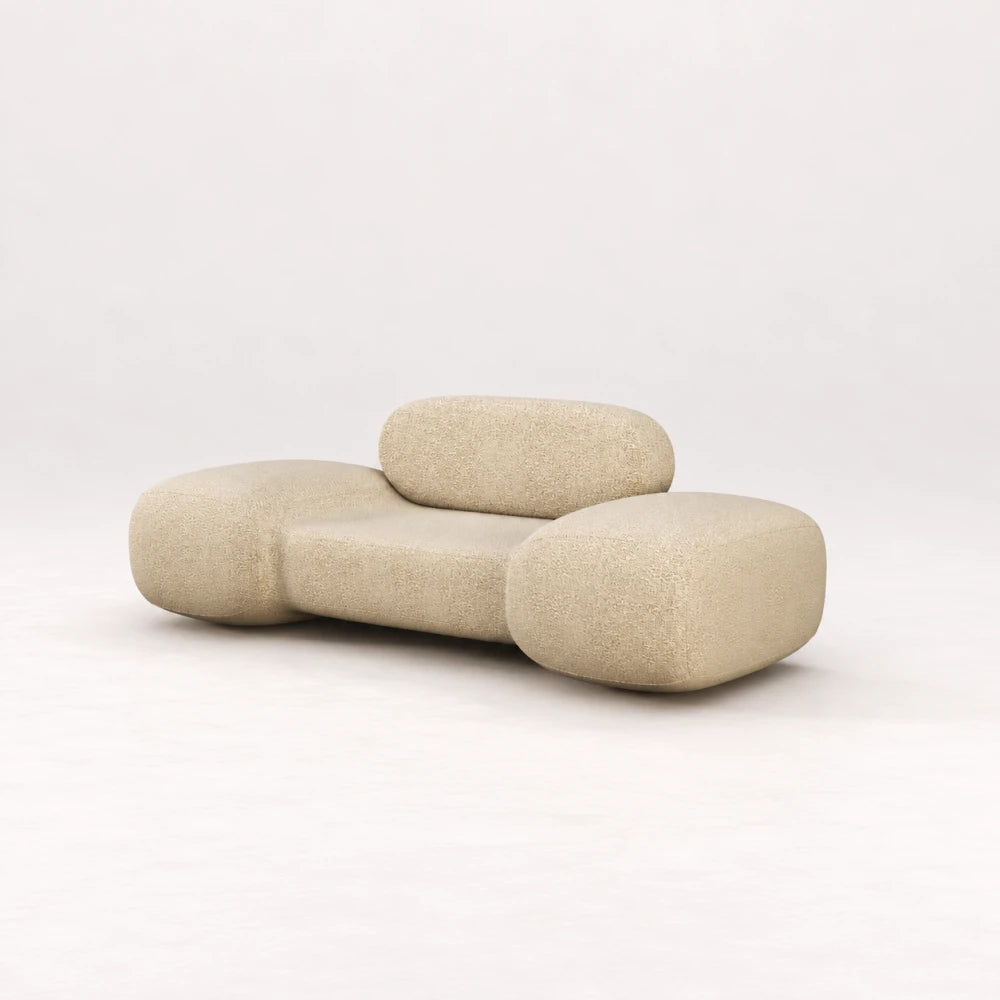 Front view of the Infinity Armchair 02 by Eva Szumilas in textured ivory upholstery, with a low seat, rounded backrest and generously curved arms.