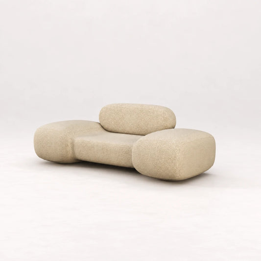Front view of the Infinity Armchair 02 by Eva Szumilas in textured ivory upholstery, with a low seat, rounded backrest and generously curved arms.