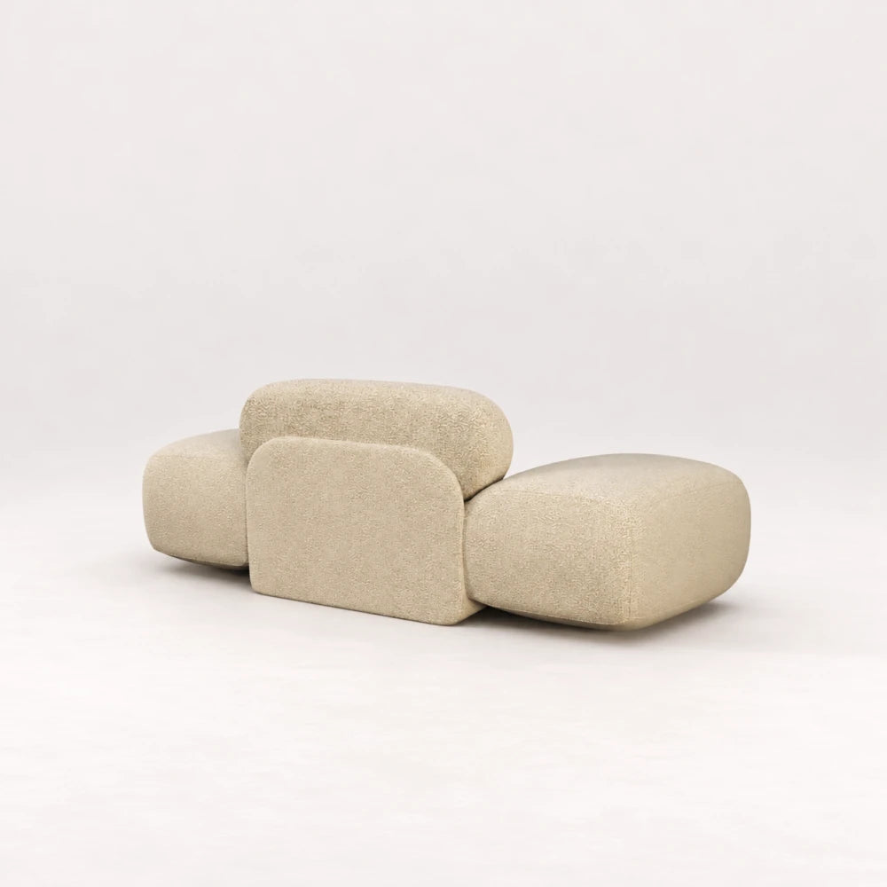 Rear view of the Infinity Armchair 02 by Eva Szumilas in textured ivory upholstery, highlighting its central padded support panel and oversized rounded arms.