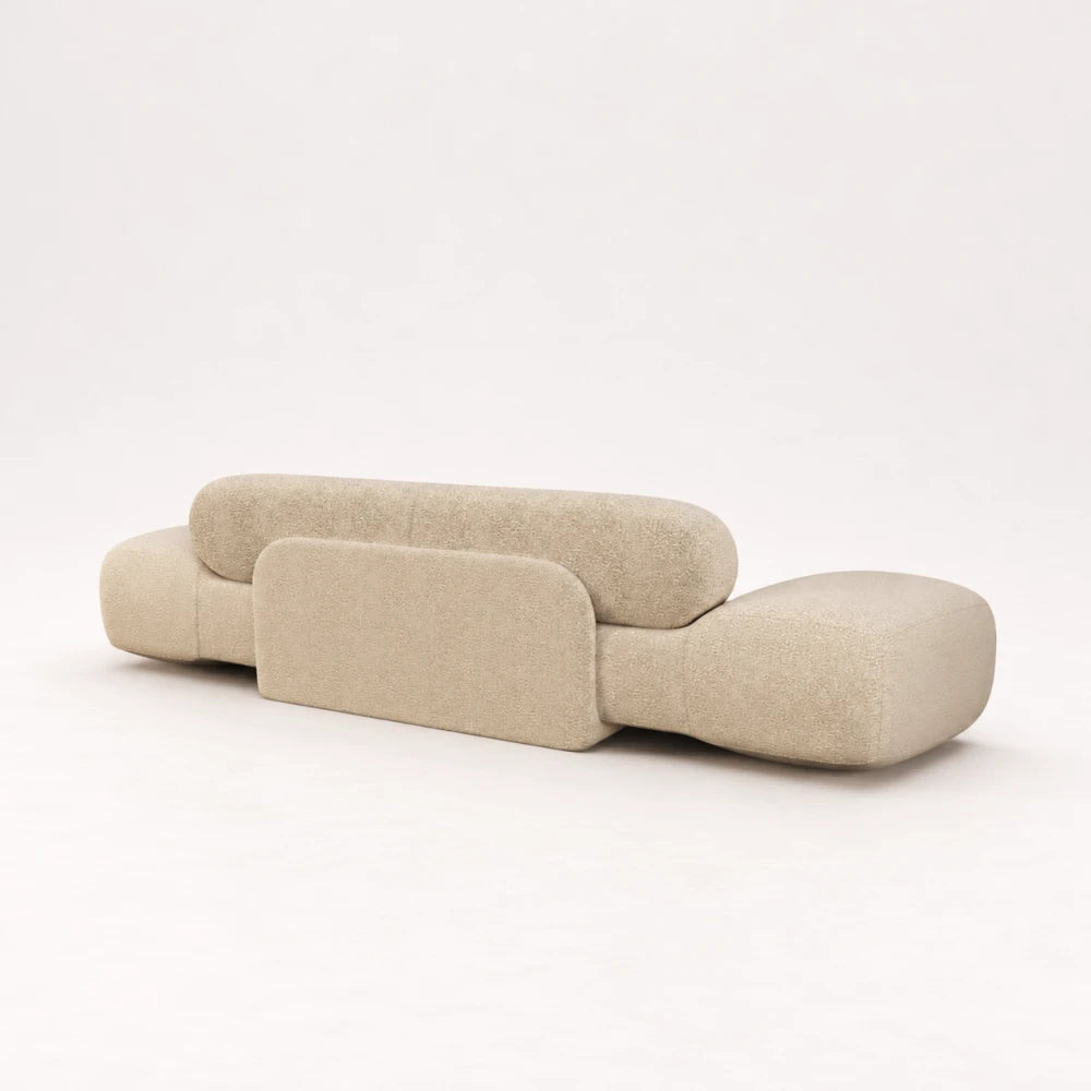 Rear view of the Infinity Sofa 02 by Eva Szumilas in textured ivory upholstery, with a rounded central support panel and softly curved ends.