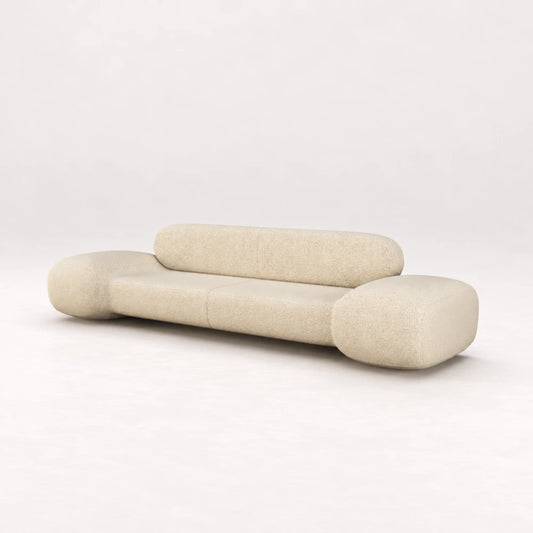 Front view of the Infinity Sofa 02 by Eva Szumilas in textured ivory upholstery, showing its low seat, pill-shaped backrest and oversized rounded arms.