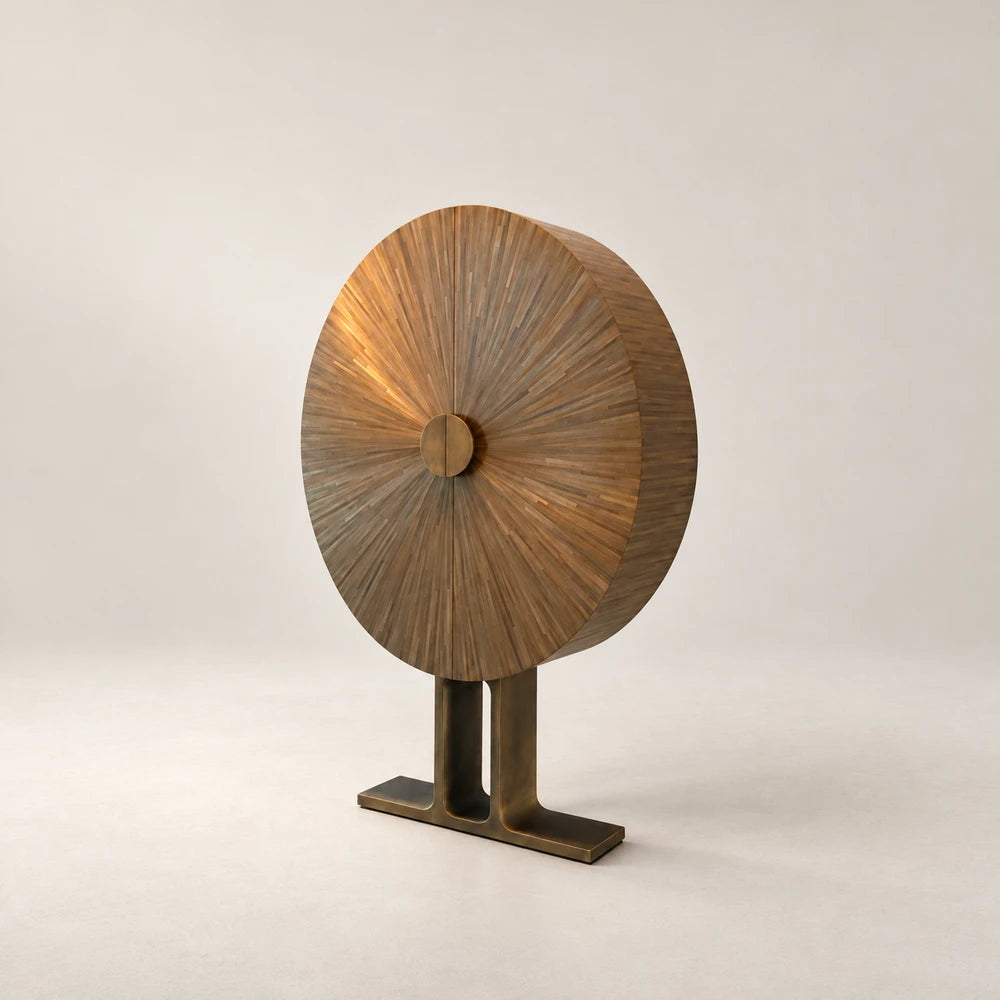 Right-hand view of the Oval Cabinet by Eva Szumilas, highlighting its deep curved wooden body, sunburst marquetry doors and sculptural metal base.