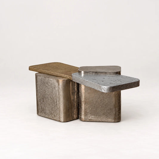 Scorpio 62 Coffee Table by Eva Szumilas, with overlapping gold-toned and silver-toned tops above textured metallic block supports with rounded corners.