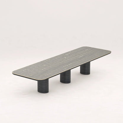 DT01 Dining Table from the X Collection by Eva Szumilas in black wood, with a long rounded rectangular top, linear arrow inlays and three cylindrical supports.