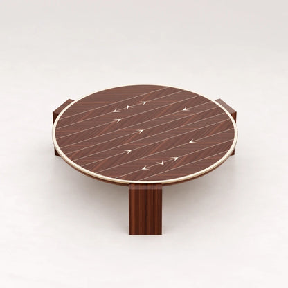 CT01 Coffee Table from the X Collection by Eva Szumilas in reddish wood, with a round top, pale rim, arrow inlays and three block legs.