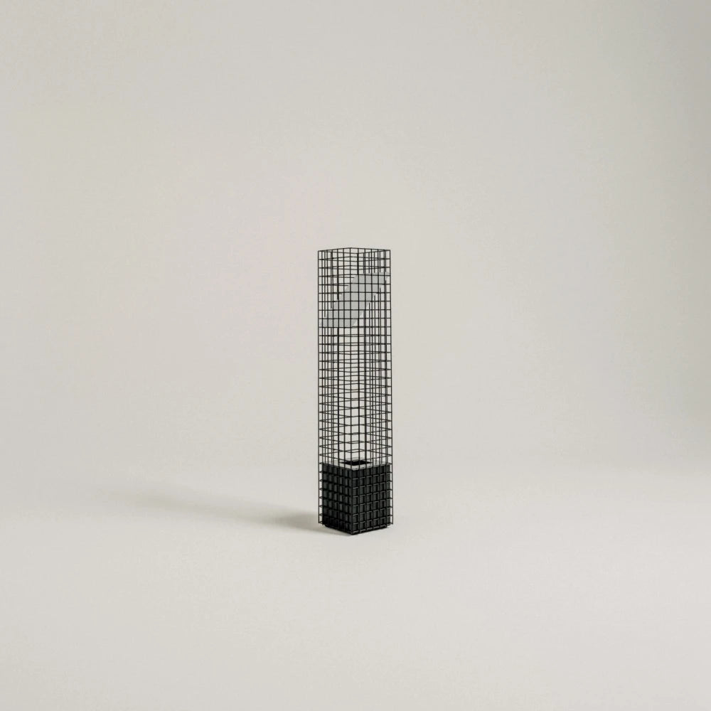 Full studio view of the unlit black Ami Table Lamp by Garnier Pingree, with a slender metal grid column and solid square base.