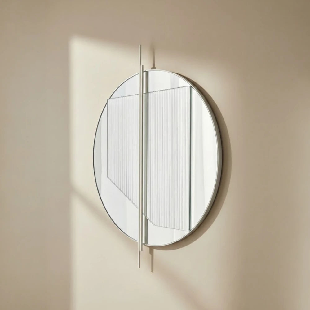 Small Claude Mirror by Garnier Pingree in sunlight, with ribbed glass and projecting vertical rods casting shadows on a beige wall.