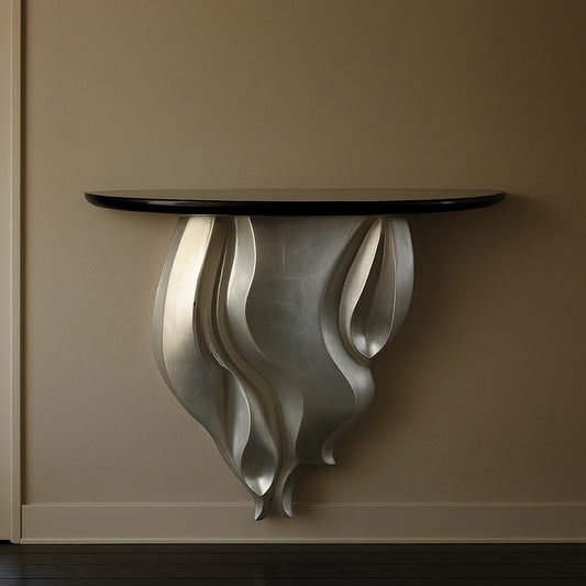Liberty Console by Garnier Pingree mounted on a warm beige wall, with a glossy black top and flowing silver-toned sculptural support.