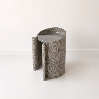 Volute Side Table by Garnier Pingree in the Sottsass finish, with dark wavy wood grain, curled front edges and a grey stone top.