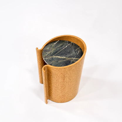 Elevated view of the maple Volute Side Table by Garnier Pingree, showing its dark green veined stone top and golden curved wooden shell.