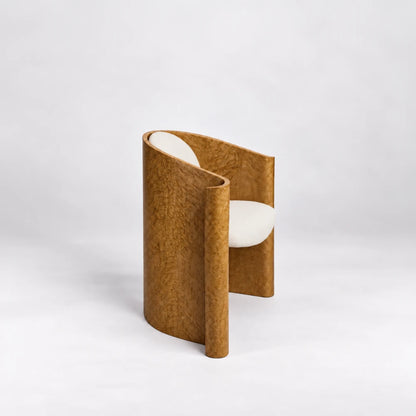 Side view of the Volute Chair by Garnier Pingree, highlighting its sweeping wooden shell, figured grain and curled front edge.