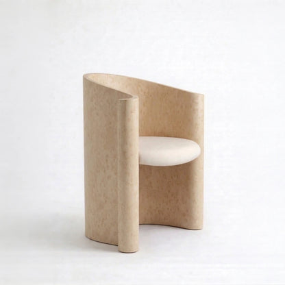 Volute Chair by Garnier Pingree in the pale Dune finish, showing its curved wooden shell, rolled front edges and cream seat.