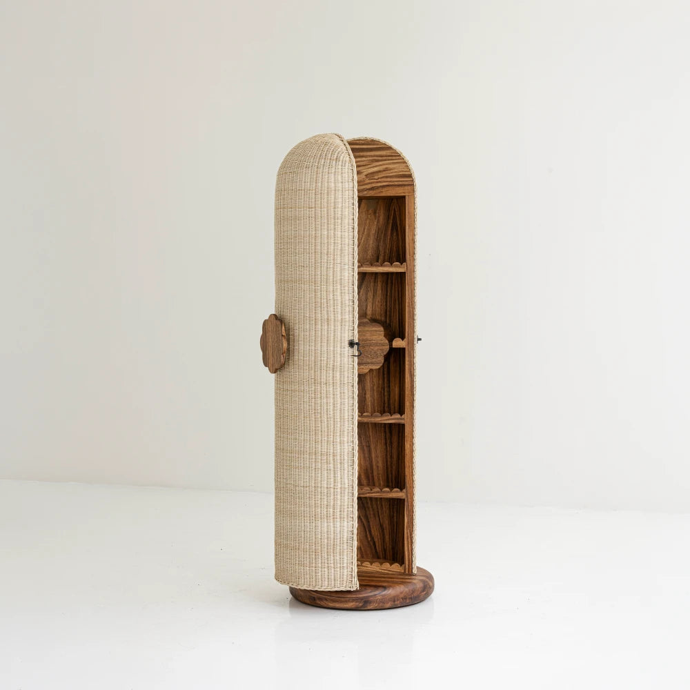 Lola Vanity in parota wood and woven mimbre by Joyful Objects, three-quarter view with the cabinet door ajar
