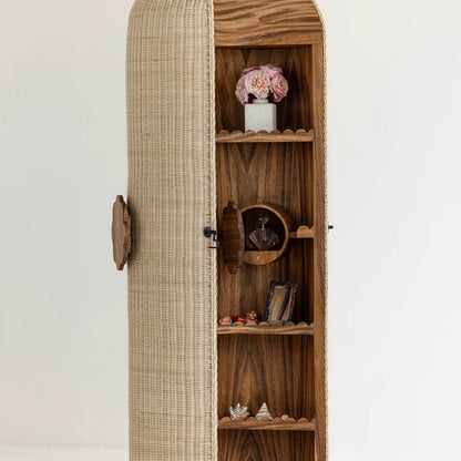 Close-up of the woven mimbre door and parota wood storage shelves of Lola Vanity