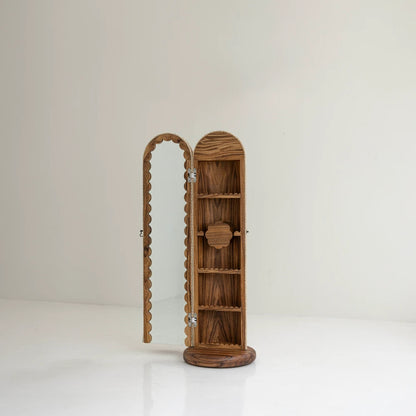 Lola Vanity by Joyful Objects with its mirrored door open, revealing the parota wood shelves