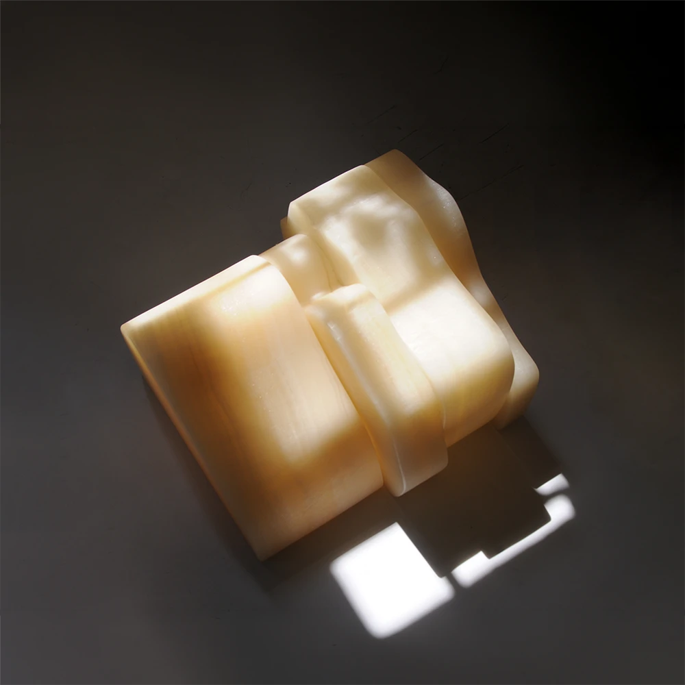 Overhead view of the closed White Moth Nightstand, highlighting its layered white onyx construction