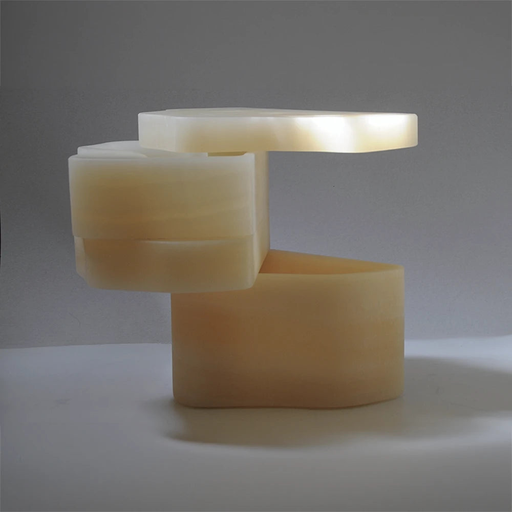 Side view of the open White Moth Nightstand showing its pivoting translucent onyx compartments