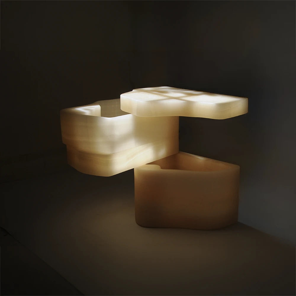 Open White Moth Nightstand by Panorammma with sunlight passing through its translucent white onyx