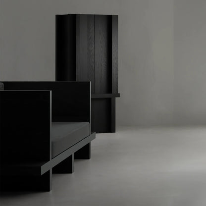 Three-quarter view of the Itooraba Cabinet by Sizar Alexis, highlighting its vertical proportions, black pine grain and projecting horizontal frame.