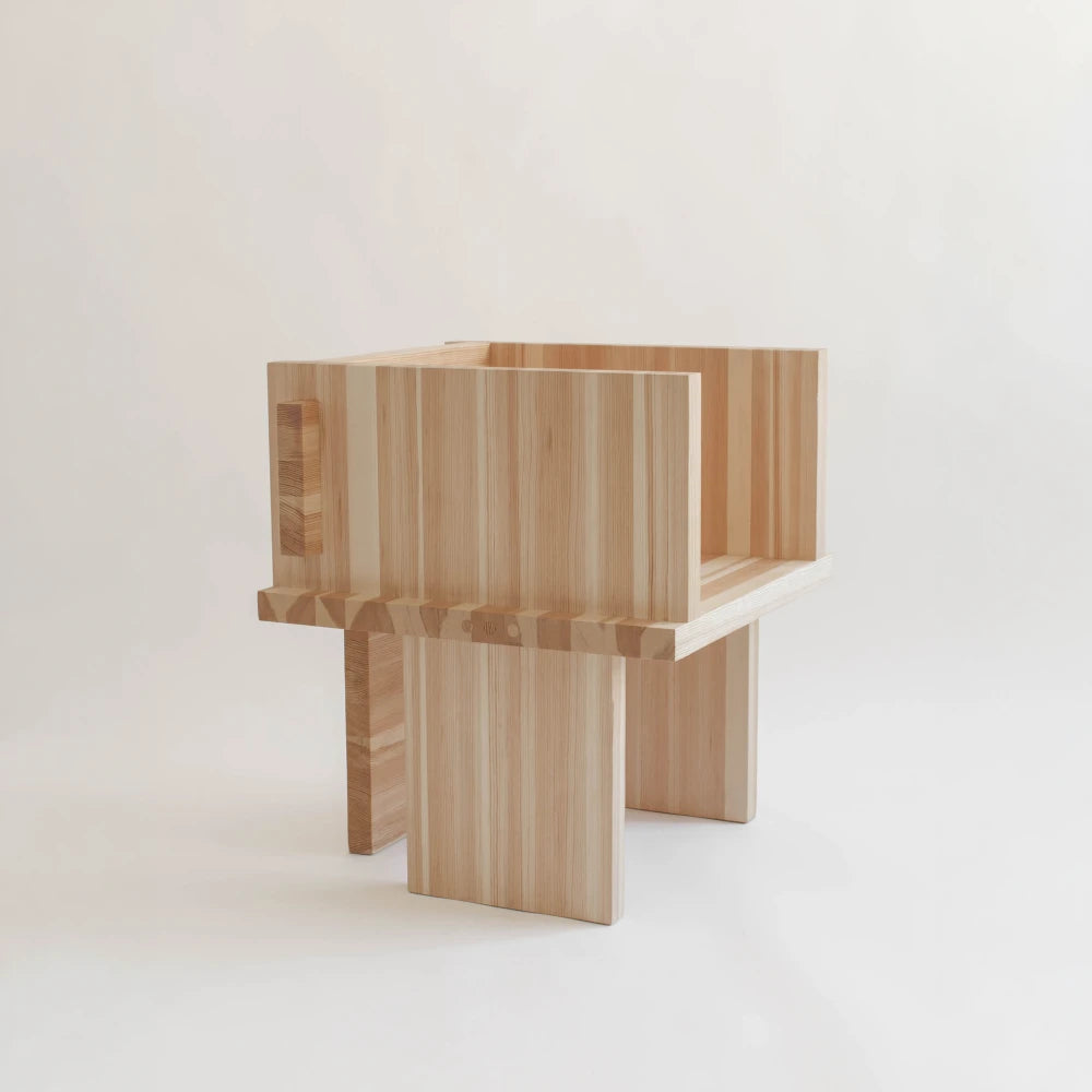 Itooraba Chair by Sizar Alexis presented against a neutral background, highlighting its natural pine grain and architectural construction.