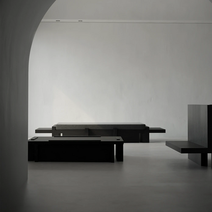 Itooraba Coffee Table by Sizar Alexis viewed through an archway within a minimalist interior furnished with coordinating black pieces.
