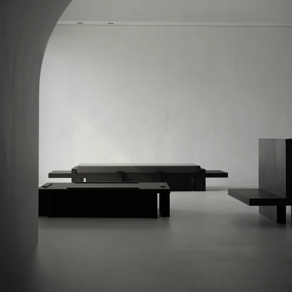 Itooraba Daybed by Sizar Alexis displayed in a minimalist interior, with its low black wooden frame and dark upholstered cushion.