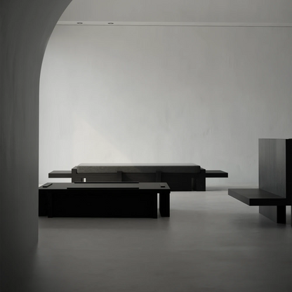 Itooraba Daybed by Sizar Alexis displayed in a minimalist interior, with its low black wooden frame and dark upholstered cushion.