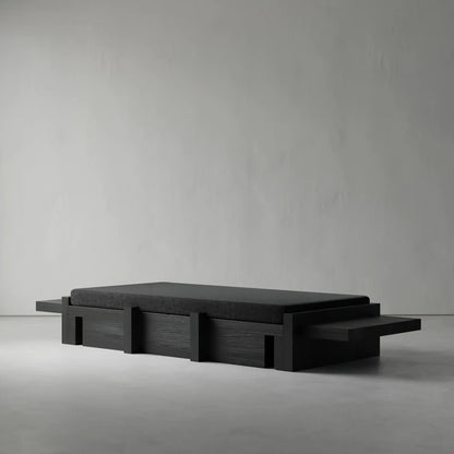 Three-quarter view of the Itooraba Daybed by Sizar Alexis, highlighting its dark cushion, extended side platforms and geometric wooden structure.