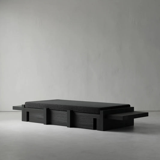Three-quarter view of the Itooraba Daybed by Sizar Alexis, highlighting its dark cushion, extended side platforms and geometric wooden structure.