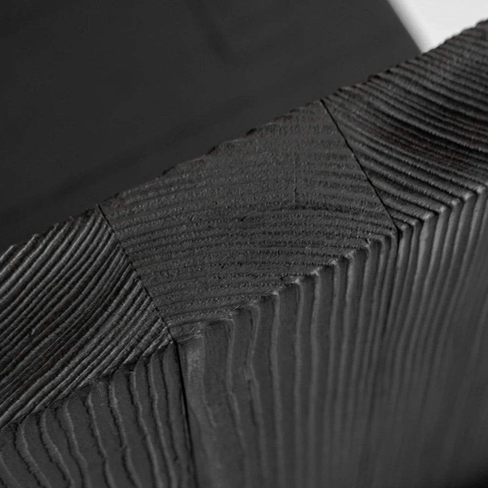 Macro detail of the Itooraba Chair by Sizar Alexis, highlighting the textured end grain and precise joints of the burned pine.