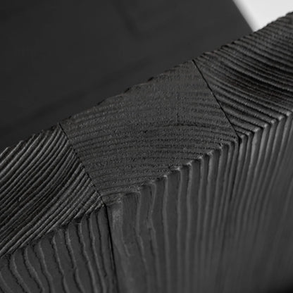 Macro detail of the Itooraba Chair by Sizar Alexis, highlighting the textured end grain and precise joints of the burned pine.