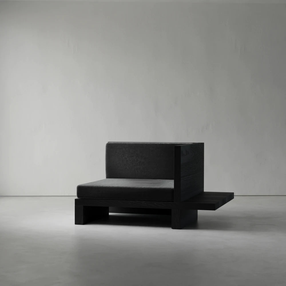 Left Corner module of the Itooraba Modular Sofa by Sizar Alexis, featuring dark cushions, a black pine frame and extended side platform.