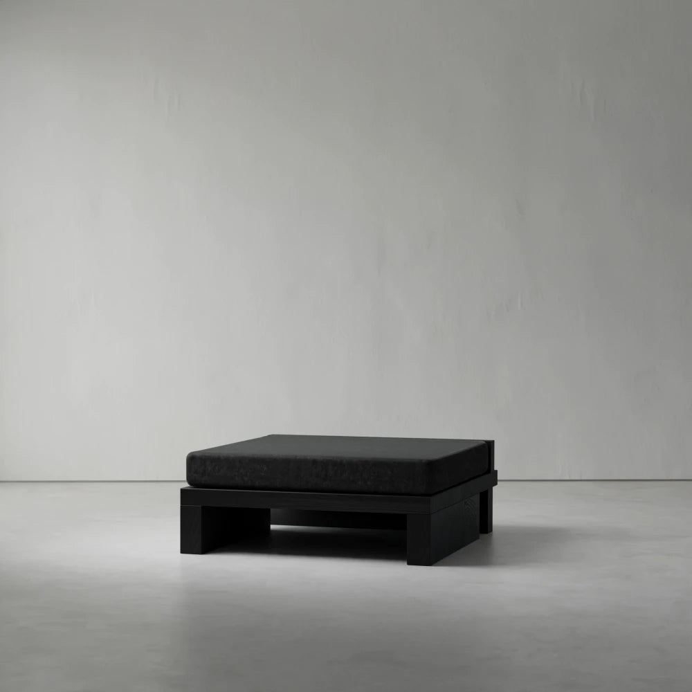 Ottoman module from the Itooraba Modular Sofa by Sizar Alexis, featuring a dark cushion supported by a geometric black pine frame.